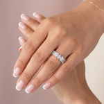 18K solid gold emerald cut diamond eternity band styled on clasped hands